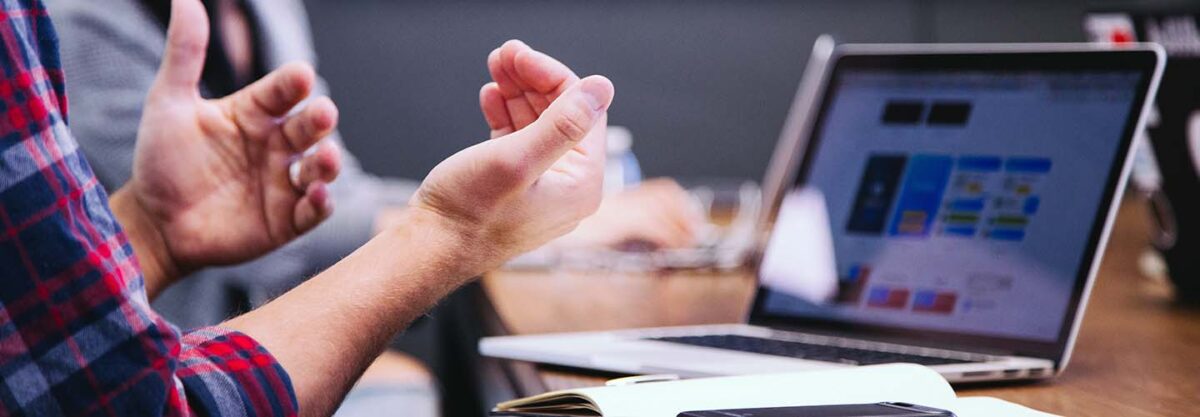 man making hand gestures during meeting
